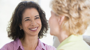 Two women in living room smiling