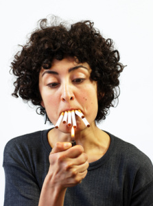 Woman lights up 5 cigarettes